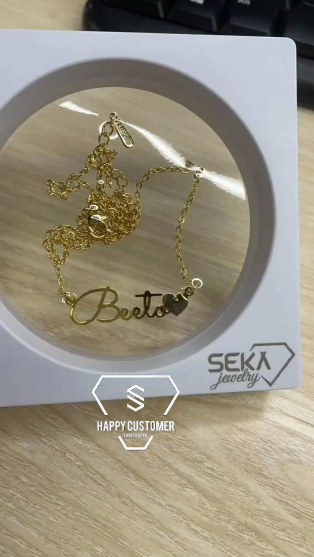 Gold name necklace with heart charm in gift packaging